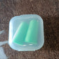 Person relaxing with soft foam earplugs in, enjoying peace and quiet.