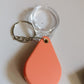Magnifying glass keychain hanging from bag as portable magnifier