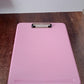 Ergonomic hard plastic clipboard with snap lock closure ideal for students and office use