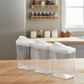 Close-up of the sliding lid mechanism on a transparent kitchen storage jar.