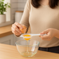 Egg yolk separator used on a bowl.
