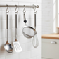 Close-up of the ergonomic handle and integrated hanging hole of the stainless steel strainer.