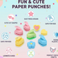 Close-up of a blue kids paper craft punch creating a star shape on paper.
