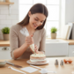 Hand using a silicone pastry brush to glaze a freshly baked cake.
