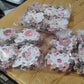 Hand holding multiple pastel-colored mini claw hair clips shaped as bears.