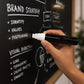 Chalk marker being used on a blackboard for clear bold lettering