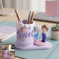 Resin sweet couple pen holder on desk with pens