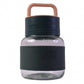 Glass water bottle with white background highlighting sleek design