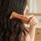 Men and women using wooden comb for daily hair care
