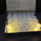 Assortment of glowing LED tea light candles creating a warm ambiance.
