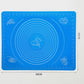 Durable silicone mat being folded to demonstrate its flexibility and ease of storage.