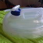 Compact and travel-friendly collapsible water carrier for easy storage.
