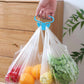 Lifestyle shot of the portable bag holder in use, reducing strain on hands, includes two pieces.