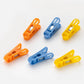 Durable non-slip plastic clips for laundry drying in bright colours.