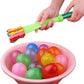 Close-up of a hand holding a cluster of brightly colored water balloons.