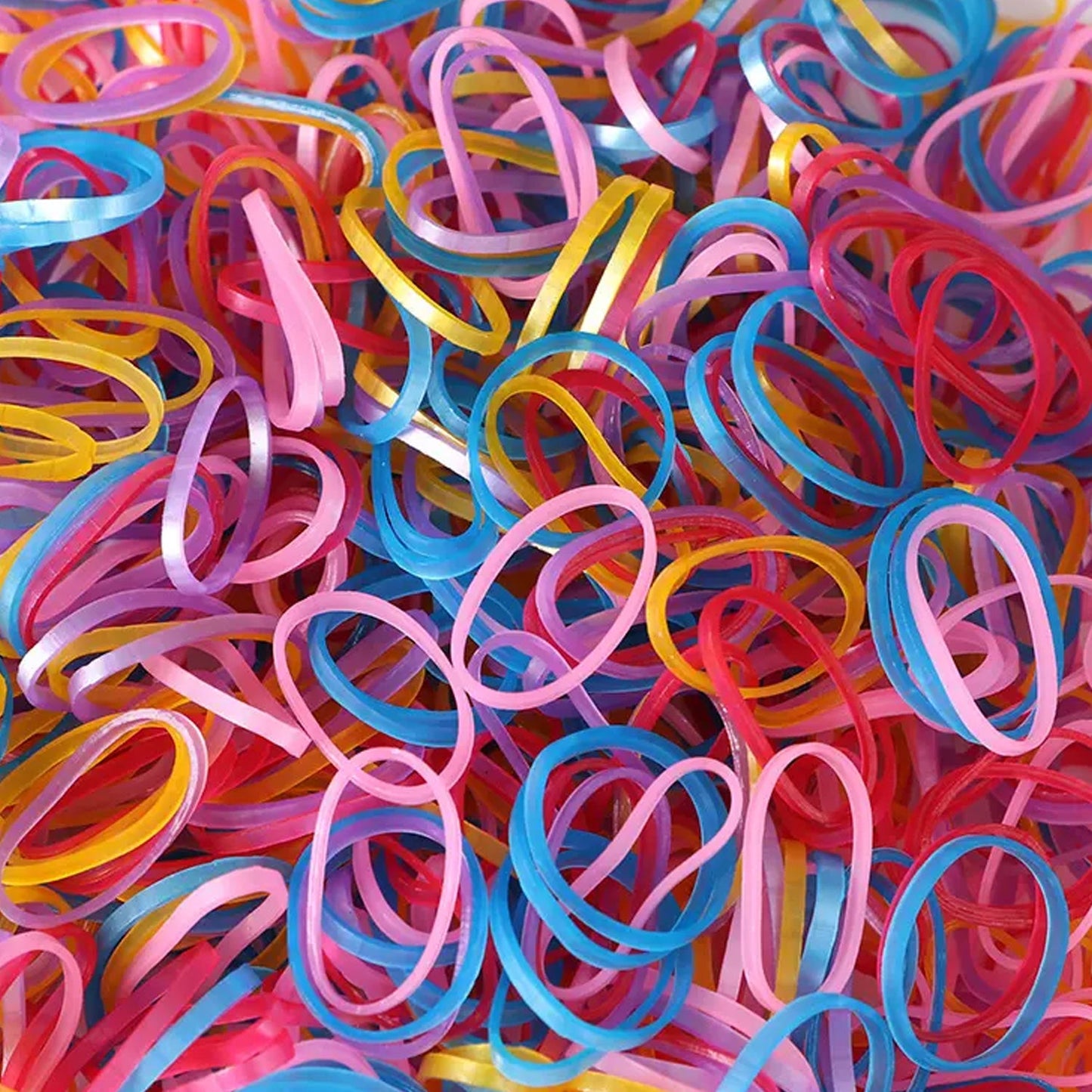 Vibrant multicolor rubber bands neatly stacked in a pile.