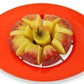 An apple being perfectly sliced into 8 pieces by the Quickslice apple corer.