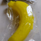 Vertical shot of the vibrant yellow banana case, showcasing its slim profile.
