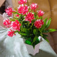 An artificial flower plant in a stylish pot, ready to enhance your home office decor.