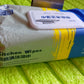 Velvet Wipe cleaning a greasy kitchen cooktop, demonstrating effective grime removal.