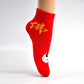 A pair of comfortable designer socks featuring a festive theme, ideal for gifting.