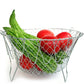 Stainless steel strainer basket with ergonomic handles for safe and easy lifting from hot liquids.
