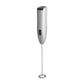 Close-up of the electric milk frother creating creamy foam in a mug.