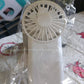 Detailed view of the fan's protective grille and blades, highlighting its design.