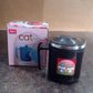Hand holding the compact 250 ml insulated cat mug, perfect for travel.