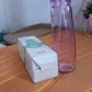 Vertical view of Own Hydrate glass water bottle with BPA-free plastic cap