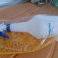 Multipurpose plastic spray bottle with 1 litre capacity on green background