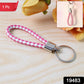 Close-up view of braided two-tone leather-style keychain with metal ring