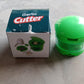 Garlic crusher with a detachable green container for easy collection and cleaning.
