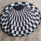 Full view of 3D space round carpet showcasing checkered pattern