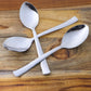 Three rust-resistant dining spoons with smooth oval bowls and comfortable grip handles