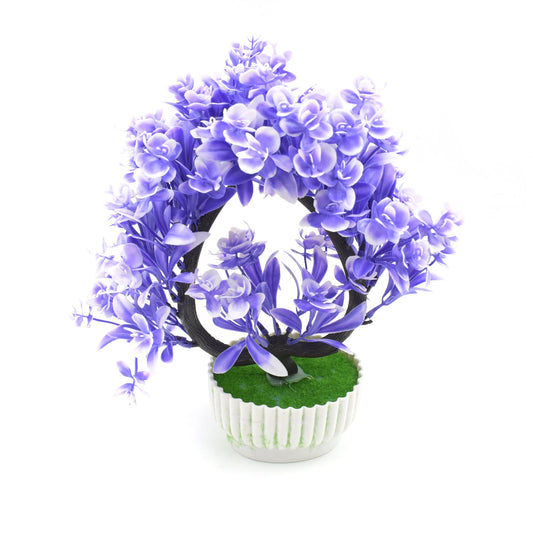 Close-up of the realistic green leaves and delicate artificial flowers in a white pot, showcasing its quality.