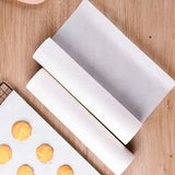 Roll of non-stick parchment paper for baking and cooking on a wooden surface.
