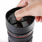 Ergonomic camera lens mug with a comfortable ribbed grip, ready for your drink.