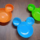 A red Mickey Mouse Kids Plate filled with various child-friendly food items, ready for mealtime.