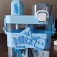 Kids water bottle with straw and shoulder strap hanging, ready for adventure.