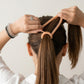 Stretching spiral hair band demonstrating elasticity