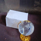 Hand holding the compact Crystal World Globe, illustrating its portable size and crystal clarity.