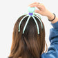 User demonstrating the stress relief scalp massager in action on their head.