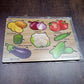 Close-up of smooth, chunky wooden vegetable puzzle pieces, safe for little hands.
