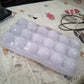 Empty 18-grid plastic egg tray, ready for fresh eggs.