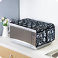 Folded cotton linen microwave cover displayed neatly on a kitchen counter.