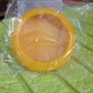 Top-down view of a compact yellow produce saver container.