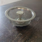 Angled view of the polished stainless steel kitchen sink strainer.