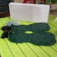 Gardener using the Lawn Aerator Sandals to improve soil health and promote lush grass growth.