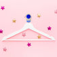Colorful plastic ball-shaped wall hook holding bathroom towel